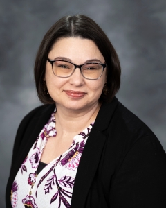 headshot of a woman with dark hair and glasses (Jane Flegal)